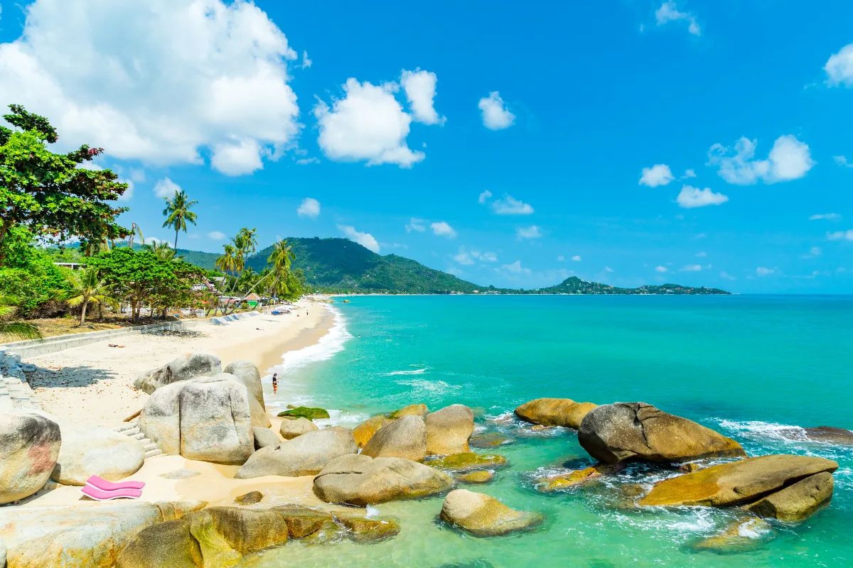 Palm-fringed beach with granite rocks on Koh Samui